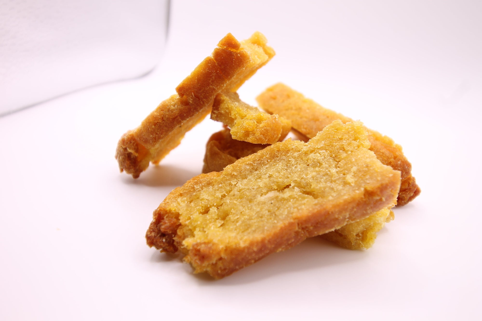Stack of Daisy Roo Alaskan cod dog treats on a white background