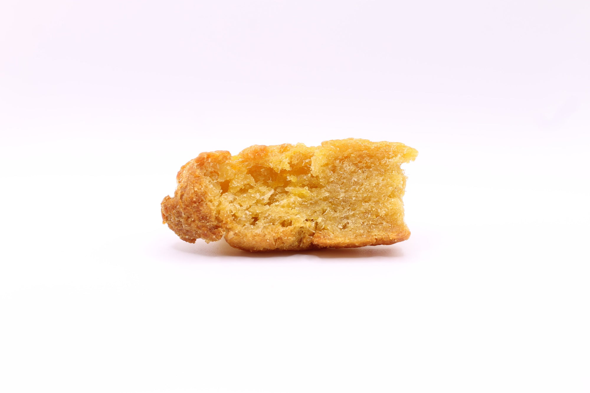 Single Daisy Roo Alaskan cod dog treat on a white background