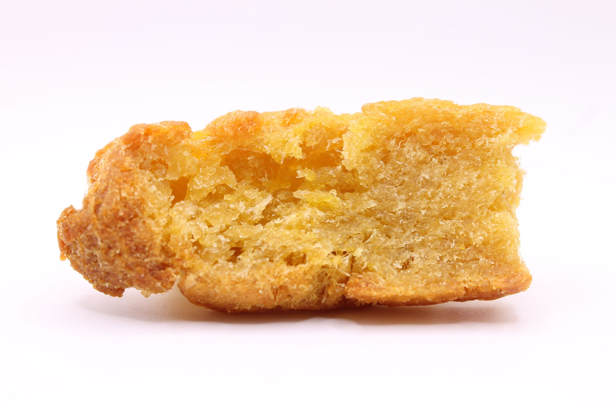 Single Daisy Roo Alaskan cod dog treat on a white background