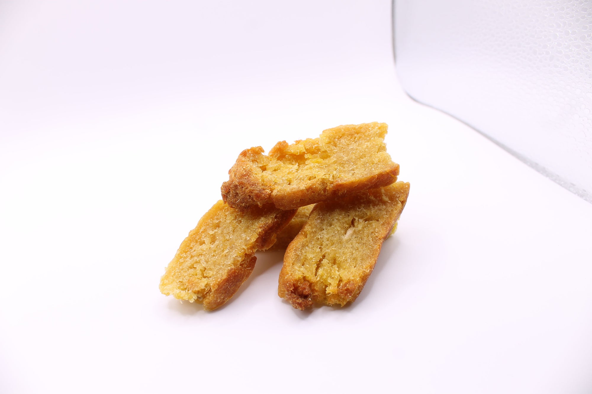 Stack of Daisy Roo Alaskan cod dog treats on a white background