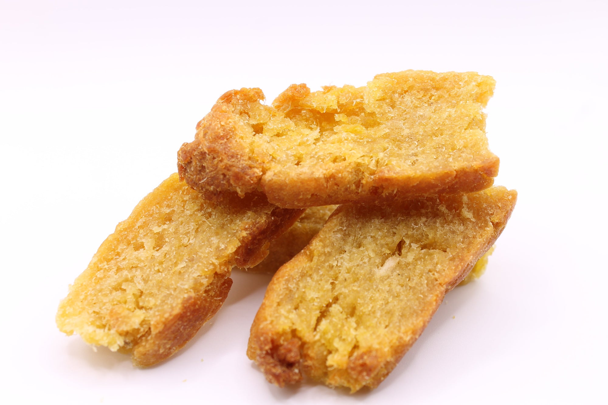 Stack of Daisy Roo Alaskan cod dog treats on a white background
