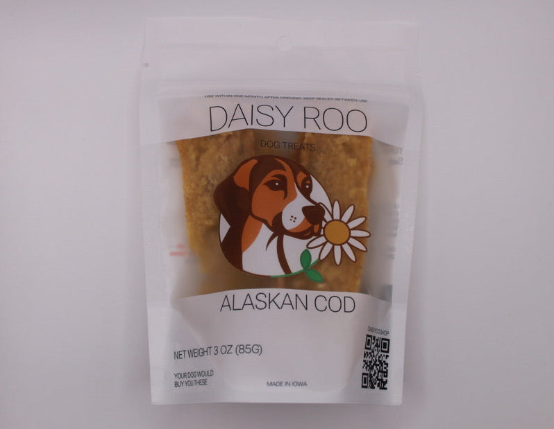 Daisy Roo Alaskan Cod pet food package on a white textured surface